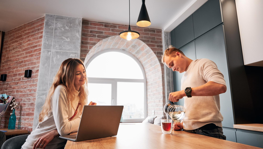 charming-woman-using-laptop-spending-time-with-husband-home.jpg