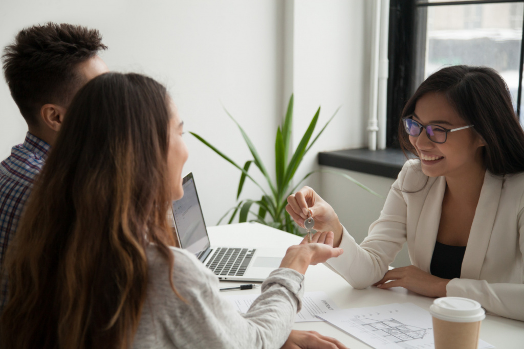 female-real-estate-agent-giving-keys-excited-couple.jpg