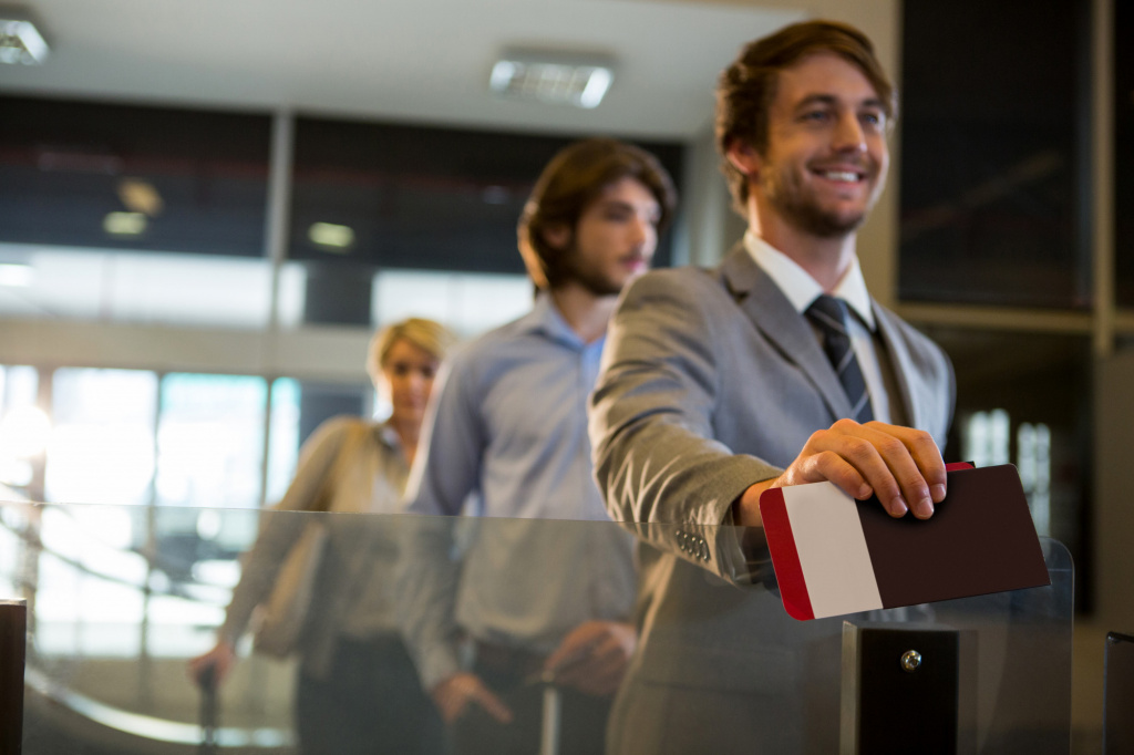 businessman-standing-with-boarding-pass-check-counter.jpg